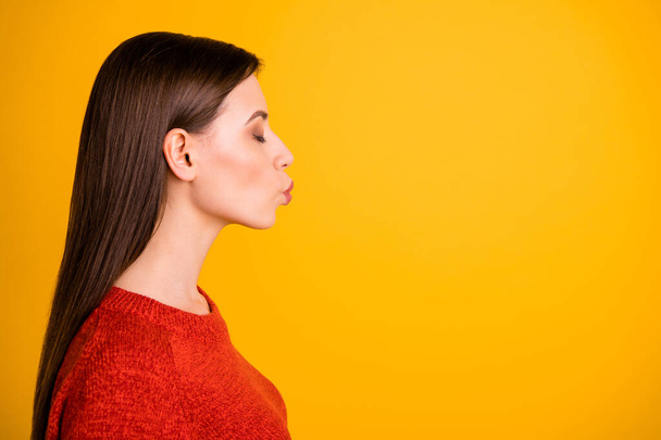 Photo of white trendy fascinating young beloved millennial girl kissing empty space with eyes closed lips pouted isolated over yellow vibrant color background - Fotoğraf, Görsel