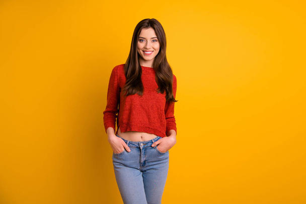 Photo of cute charming nice fascinating youngster holding hands in pockets wearing denim smiling toothily isolated over vivid color yellow background - Foto, imagen