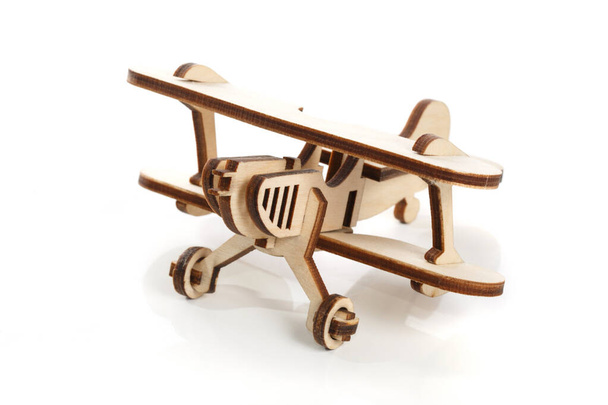 Wooden toy model of a corn dug plane isolated on a white background. - Foto, Bild