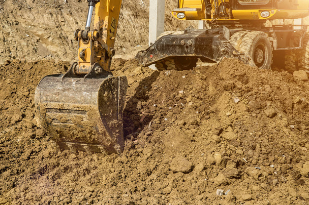 Working Excavator Tractor Digging A Trench At Construction Site. - Foto, Imagen