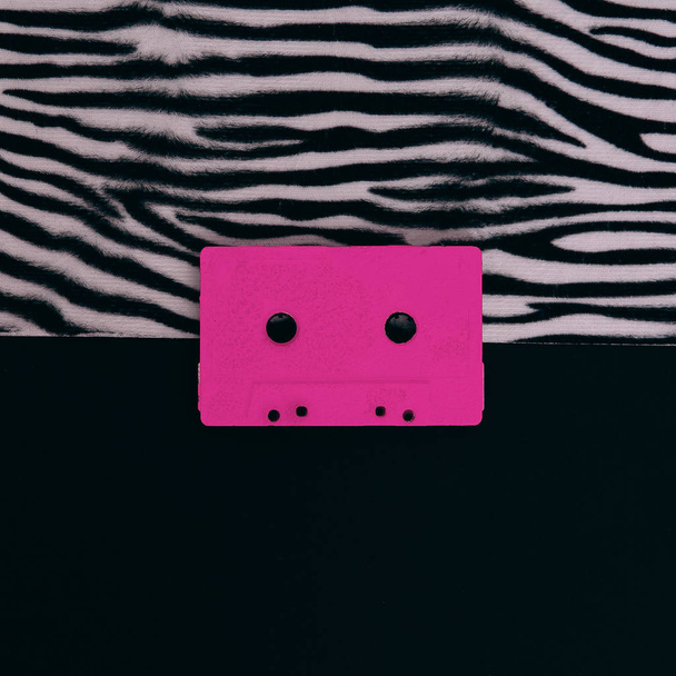 Pink Audio Cassette on animal zebra print. Minimal flat lay art - Φωτογραφία, εικόνα