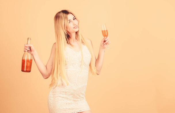 Aperitif concept. Luxury alcohol. Bar restaurant. Club and adult alcohol party. Girl drinking pearl glitter champagne. Woman hold glass alcohol drink. Attractive lady enjoy peach orange liqueur - Φωτογραφία, εικόνα