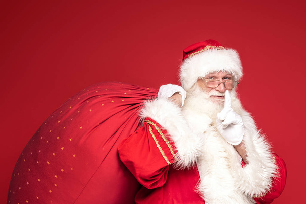 Real Santa Claus smiling,holding big gift bag. - Photo, image