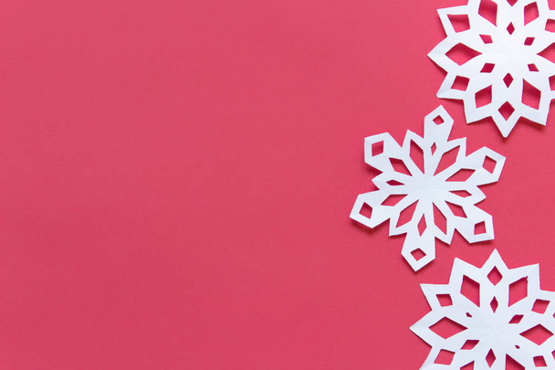 Red background with blank space and three white snowflakes - Fotó, kép