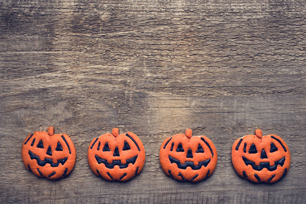 Halloween gingerbread cookies on wooden background. - Photo, image