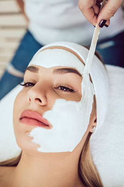 Beautiful and attractive adult woman receiving professional face skin beauty treatment - Φωτογραφία, εικόνα