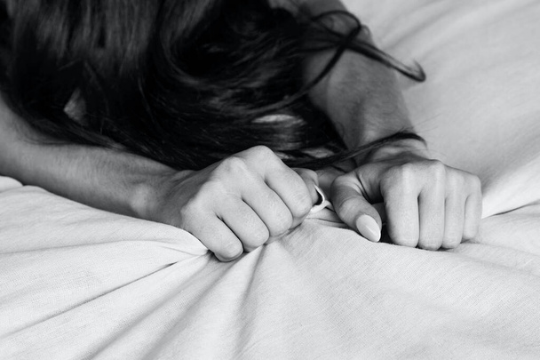 Woman's hands pulling white sheets in ecstasy, orgasm - Φωτογραφία, εικόνα