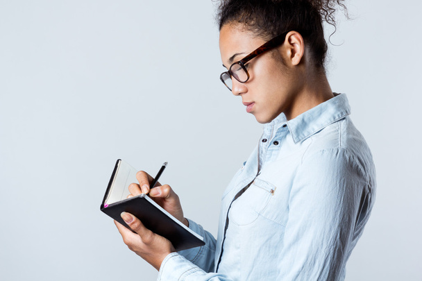 Young black woman taking notes at home - Φωτογραφία, εικόνα