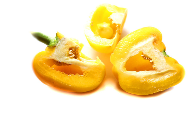 sweet paprika, yellow pepper chopped into pieces, on a wooden board background - Foto, immagini
