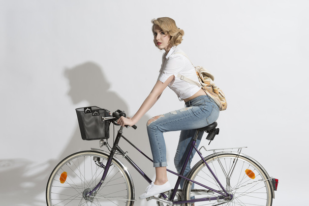 pretty woman on a bicycle - Фото, изображение