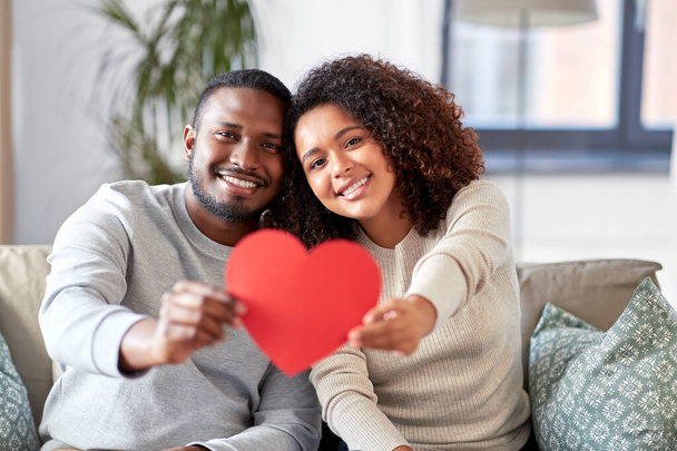 happy african american couple with heart at home - Fotoğraf, Görsel