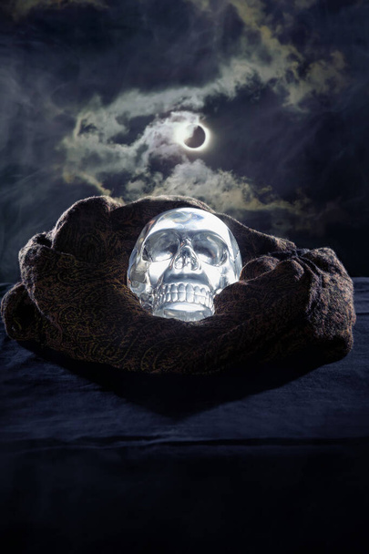 Scary or creepy glowing crystal skull on Halloween holiday or Dia De Los Muertos Day of the Dead festival.  Depicts horror theme and superstition.  - Photo, image