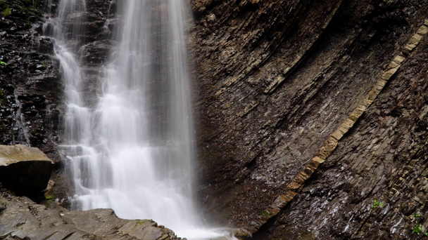 Beautiful waterfall in summer. A fast waterfall. View of the waterfall from below - Footage, Video