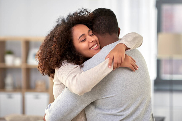 happy african american couple hugging at home - Φωτογραφία, εικόνα