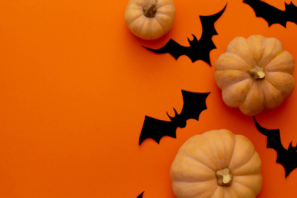 Pumpkins on orange table. Halloween background - 写真・画像
