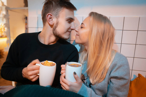 guy with a girl drink hot coffee and tea - Foto, afbeelding