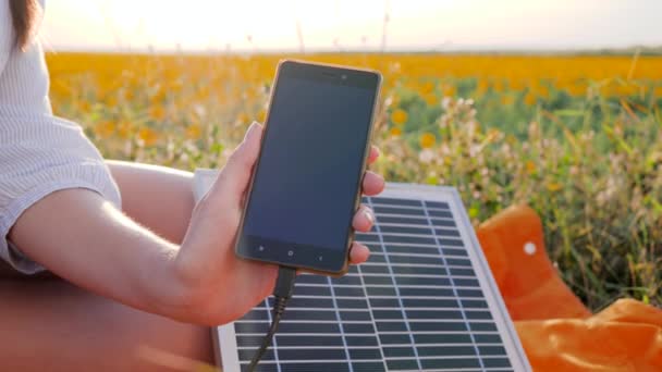 cell phone connected to solar photovoltaic panels outdoor, battery charger solar powered, renewable energy, close up - Footage, Video