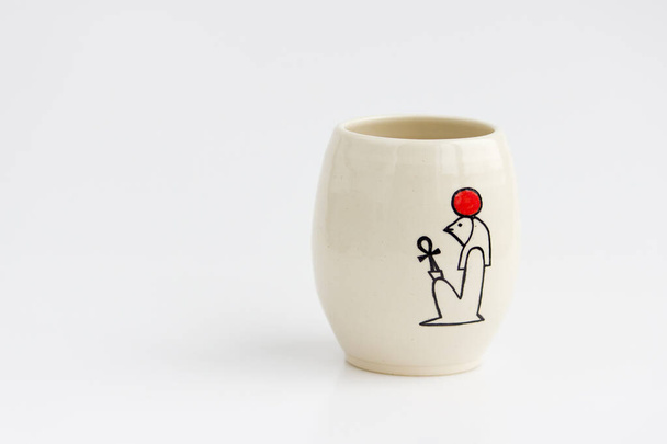 clay vase with the ancient Egyptian hieroglyph God Ra on a white background - Photo, Image