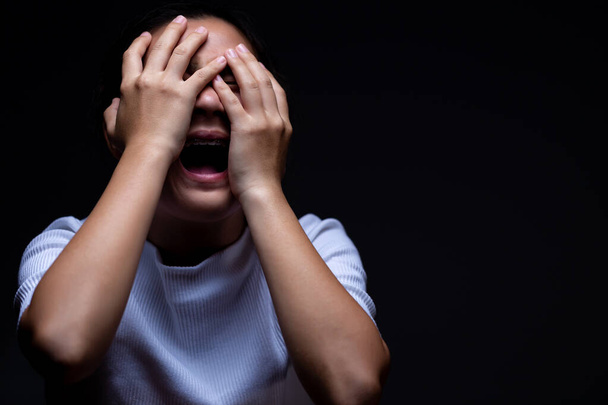 Woman covering her eyes and screaming - Photo, image