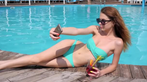 fotos de vacaciones, chica hace foto en el móvil, hembra hace selfi en traje de baño con cóctel de colores
 - Metraje, vídeo