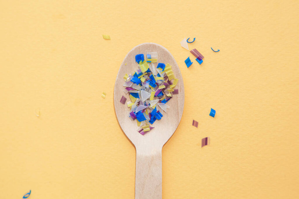 Environmental pollution and water microplastic. Micro plastic with spoon - Foto, Bild