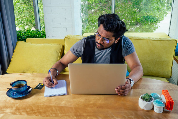 handsome and successful businessman student in a stylish well-dressed freelancer working with a laptop .freelance and remote work. - Photo, Image