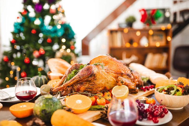 Roasted  chicken or turkey with sauce and grilled autumn vegetables: corn,pumpkin  on wooden table, top view, frame. Christmas or Thanksgiving Day food concept. - Photo, Image
