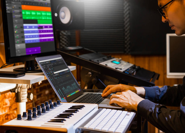 male producer, musician, composer making a song in home recording studio. music production concept - Photo, Image