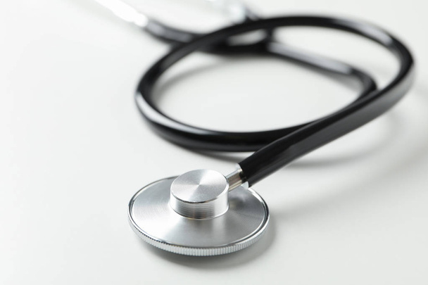 Black stethoscope on white background, close up. Healthcare - Photo, image