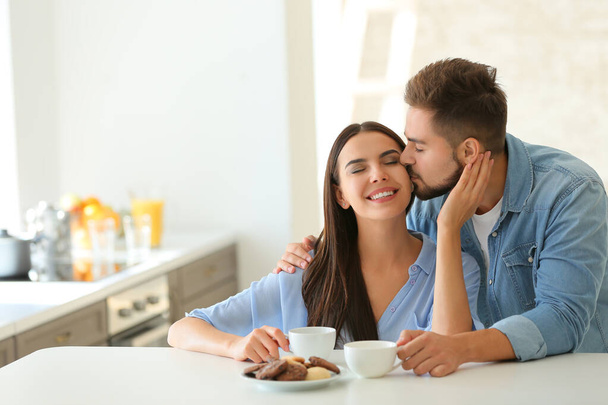 Happy young couple in kitchen at home - Photo, Image