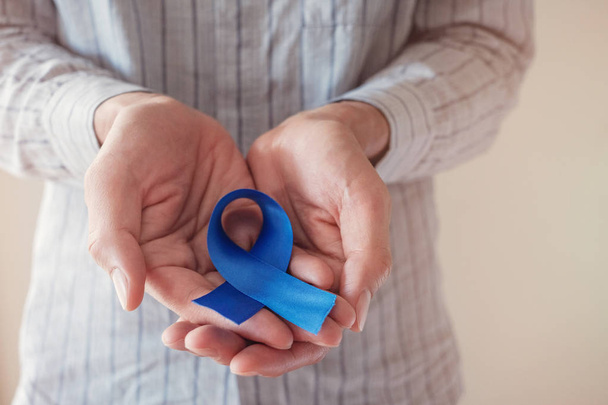 Man Hands holding blue ribbon, Prostate Cancer Awareness, Novemb - Photo, Image