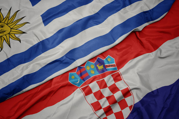 mávání barevnou vlajkou Chorvatska a národní vlajky uruguay - Fotografie, Obrázek