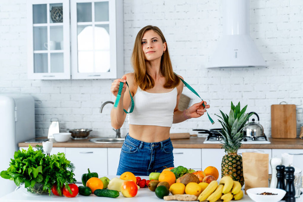 Dieting concept .Diet. Beautiful Young Woman near in the kitchen with healthy food. Fruits and Vegetables. - Φωτογραφία, εικόνα