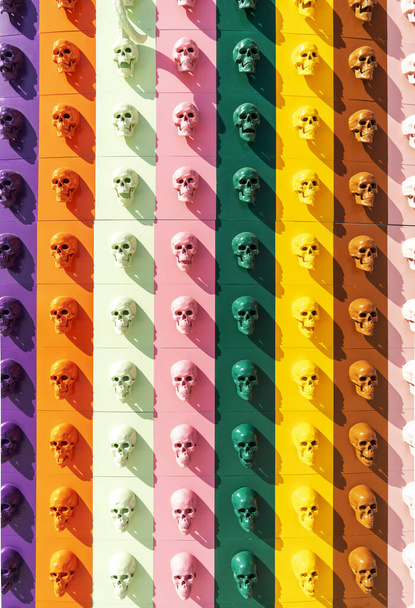 A collection of multi-colored skulls laid out in a line. Halloween concept. - Photo, image