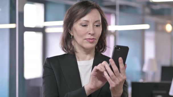 Portrait of Successful Middle Aged Businesswoman Celebrating on Smartphone with Fist - Filmagem, Vídeo