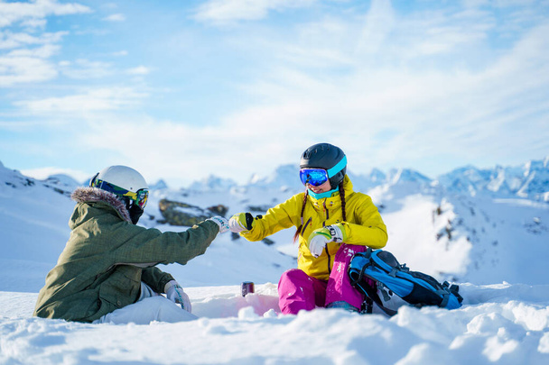 Obrázek dvou sportovců, jak si potřásají rukou na sněhu. - Fotografie, Obrázek