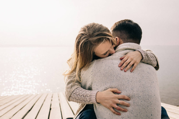 couple hugging on a pier - Фото, изображение