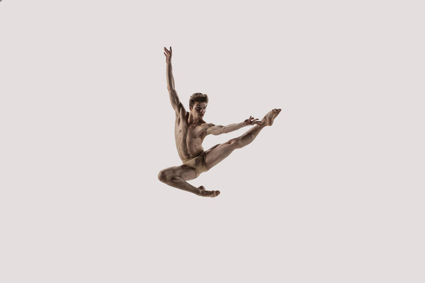 Modern ballet dancer. Contemporary art ballet. Young flexible athletic man. - 写真・画像