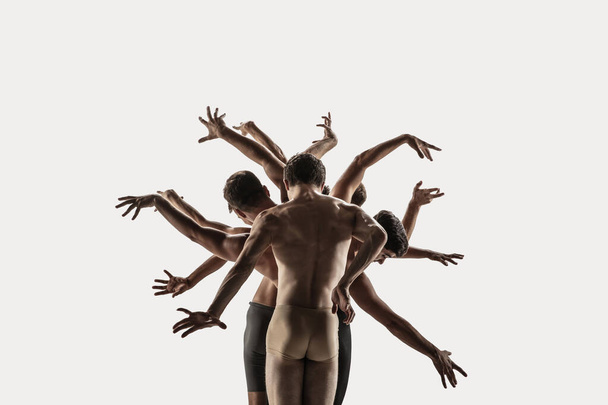 The group of modern ballet dancers. Contemporary art ballet. Young flexible athletic men and women. - 写真・画像