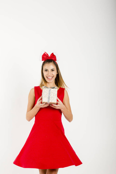 Happy teenage girl with Santa hat and big gift box - Valokuva, kuva