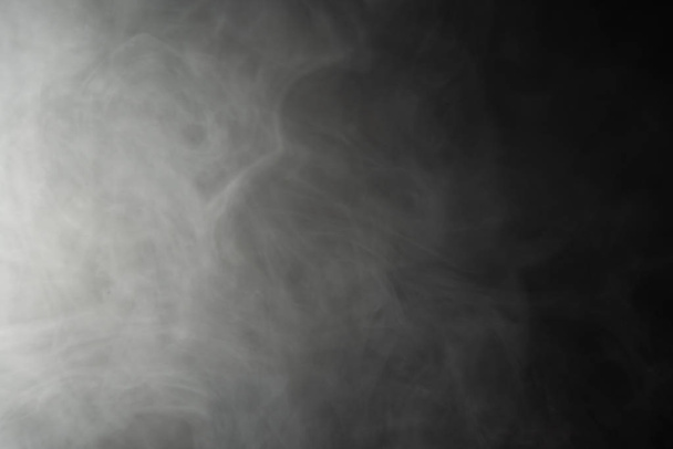 Puffs of smoke on a black background - abstract background - Фото, изображение
