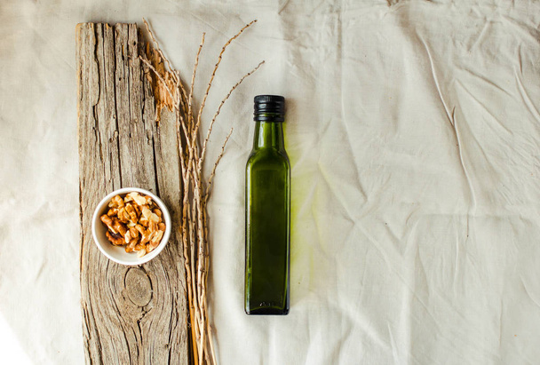 Extra virgin Walnut oil in a green glass bottle. Field products. - Fotoğraf, Görsel