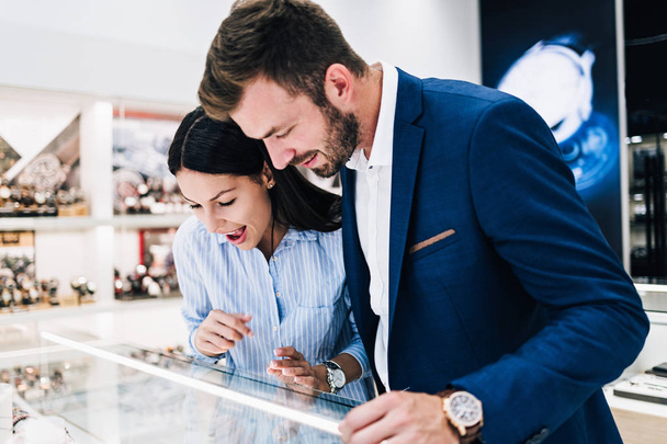 Beautiful couple enjoying in shopping at modern jewelry store.  - Fotografie, Obrázek