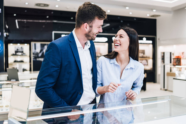 Beautiful couple enjoying in shopping at modern jewelry store.  - Foto, Imagem
