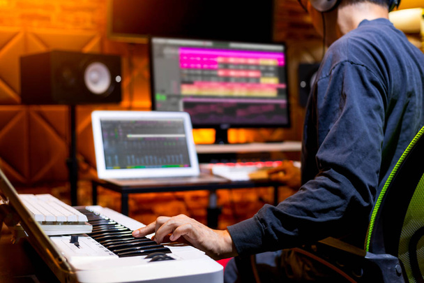 male producer, musician, composer making a song in home recording studio. music production concept - 写真・画像
