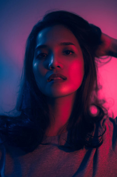 Beautiful woman face. Red and blue light color. Double light colors of potrait. - Photo, Image