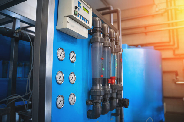 Automatische behandeling en filtratie van drinkwater in de fabriek voor de productie van gezuiverd drinkwater, blauw getint met lichteffect - Foto, afbeelding