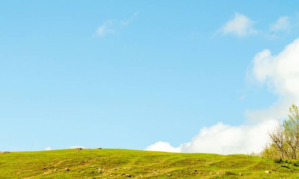 Maisema vihreä kenttä kukkulat taivas pilvet
 - Valokuva, kuva