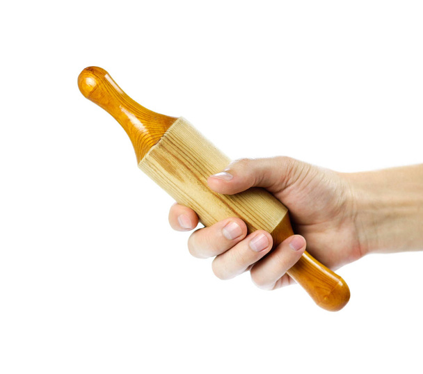 Hand holding wooden rolling pin. Close up. Isolated on white bac - Zdjęcie, obraz