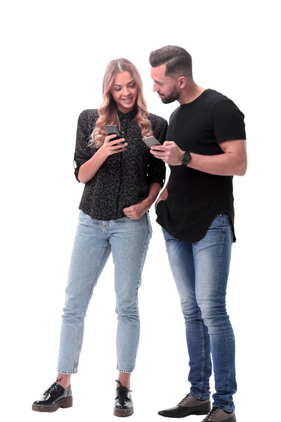 in full growth. stylish young couple with smartphones - Fotó, kép